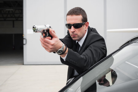 Police tactical car shooting training. Male spy agent bodyguard shooting from limousine. Security...