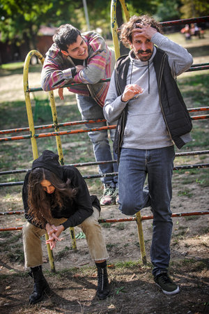 Group of relaxed and smiling happy young friends, female and male, smoking cannabis marijuana ganja...