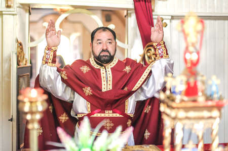Religious priest during church service. Authentic religion spiritual ceremony. Holy bible book and cross. Faith, hope, spirit and peace ritual. Real life sceneの写真素材