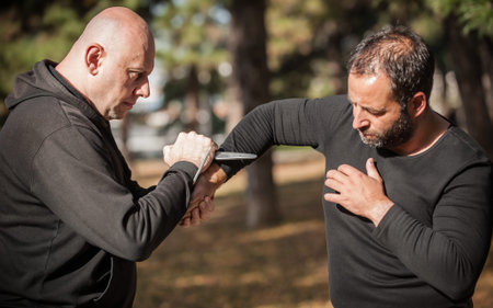 Knife vs knife fight. Kapap instructors demonstrates sombrada drill training method. Weapon disarm...