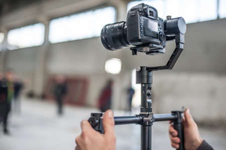 Man hand holding camera and take the photo. Selective focusの写真素材