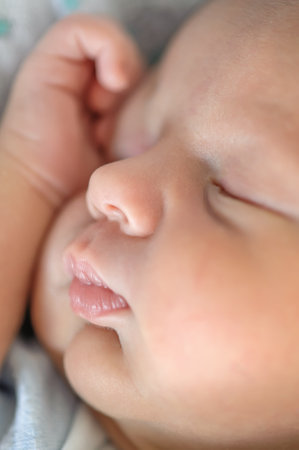 Cute detail macro portrait view of peaceful baby head face, calm sleeps soundly. Beautiful child sleeping and restingの写真素材