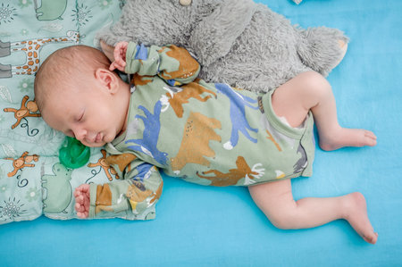 Cute little peaceful baby calm sleeps soundly in his crib in a bright room. Close-up portrait of...