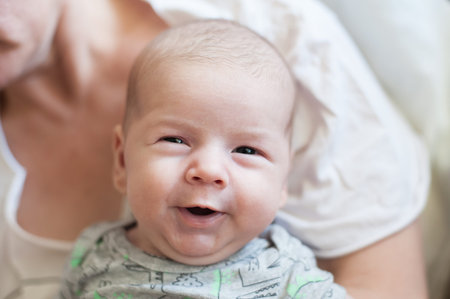 Close-up detail portrait of cute little peaceful smiling baby boy face. Joy and happiness concept....