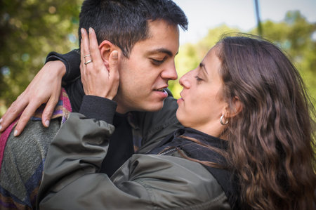 Closeup tenderly cheerful and romantic couple hugging and enjoying in love in nature outdoor. Love,...