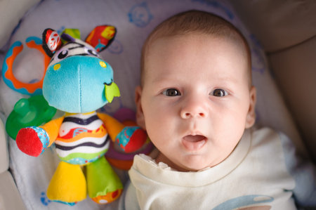 Close-up detail portrait of cute little peaceful newborn baby boy child face with beautiful open...