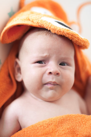 Close-up detail portrait of cute little peaceful newborn baby boy child face with beautiful open eyes. Love and family emotionの写真素材