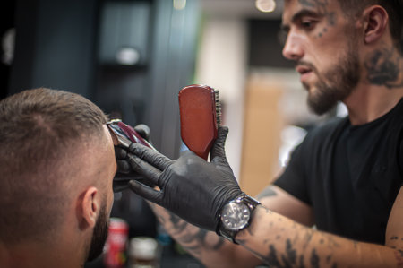 Modern urban hairdresser cut hair with hair trimmer in professional hairdressing salon and studio. Close-up detail viewの写真素材