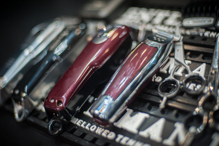 Close-up detailed view of hair trimmers and accessories in a professional hairdressing and...