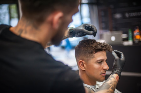 Modern urban hairdresser cut and adjusts the hairstyle in professional hairdressing salon and studio. Close-up detail viewの写真素材