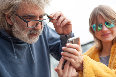 Portrait of senior man and woman using mobile phone.の写真素材