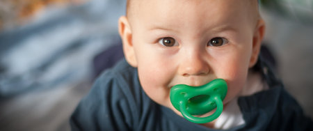 Portrait of cute happy baby boy looking at camera. Joy and happiness concept. Love and family emotionの写真素材