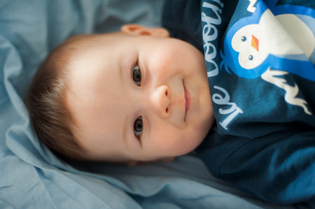 Portrait of cute happy baby boy looking at camera. Joy and happiness concept. Love and family emotionの写真素材