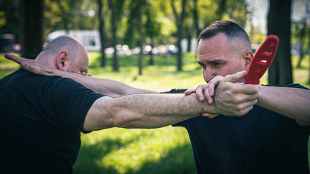 Knife attack self-defense. Techniques of disarming knife attacker. Weapon disarm training