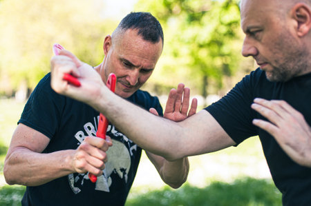 Knife vs knife fight combat training. Sumbrada training method. Plastic weapon defend demonstration drillの写真素材