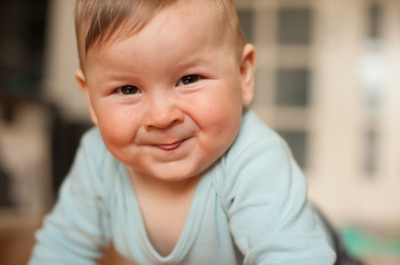 Portrait of cute happy baby boy looking at camera. Joy and happiness concept. Love and family emotionの写真素材