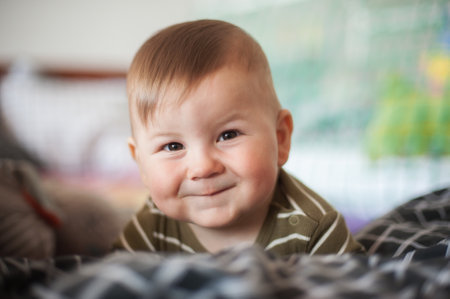 Portrait of cute happy baby boy looking at camera. Joy and happiness concept. Love and family emotionの写真素材