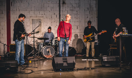 Punk rock music band group have live performance on a stage. Singer artist performer, bass and electric guitar musician players and drummerの写真素材
