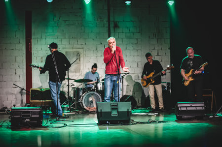 Punk rock music band group have live performance on a stage. Singer artist performer, bass and electric guitar musician players and drummerの写真素材