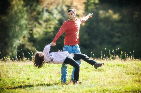 Couple in love dance in nature meadow and enjoys life freedom. Love, relationship and romance...