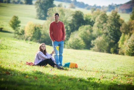 Boyfriend and girlfriend, a romantic couple in love, on the meadow grass, enjoy in lifeの写真素材
