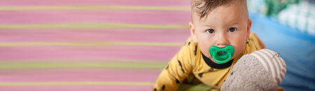 Portrait of cute baby boy lying on bed and looking at camera. Place for text. Love and family...