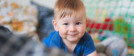 Portrait of cute happy baby boy looking at camera. Joy and happiness concept. Love and family emotionの写真素材