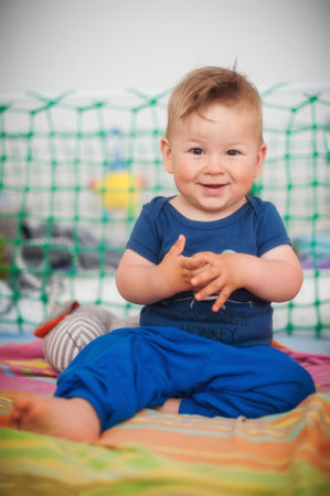 Portrait of cute happy baby boy looking at camera. Joy and happiness concept. Love and family emotionの写真素材