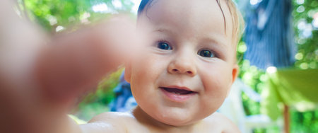 Close-up front view portrait of cute baby boy. Outdoor summer time. Joy and happiness concept. Love...