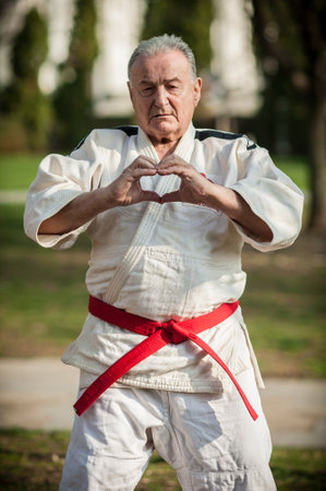 Senior man practicing karate in the park. Healthy lifestyle concept.の写真素材