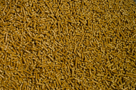 In the photograph you can see a background of pellets with bright brown colors and shadows.の写真素材