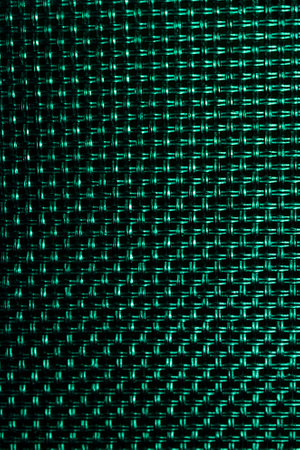 In the photograph you can see a grid with a green background, brightness, grid and mesh texture.の写真素材
