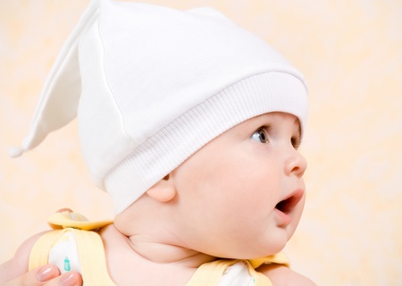 happy baby in a white hatの写真素材