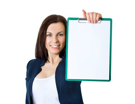A portrait of a young business woman in an office with documents in her armsの写真素材