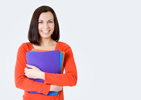 Young smiling student woman  Over gray background の写真素材