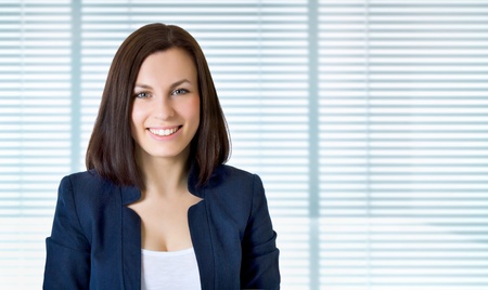 Smiling business woman. Isolated over jalousieの写真素材