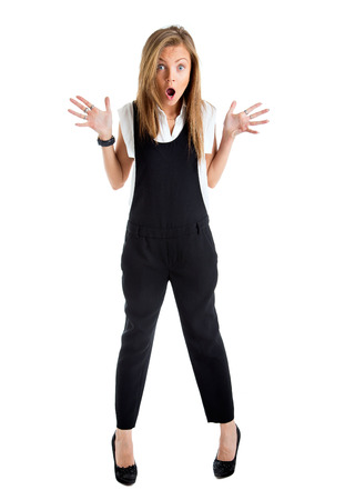 Shocked woman isolated. Businesswoman with funny surprised expression. Young business woman in full length looking at camera in high angle view.の写真素材