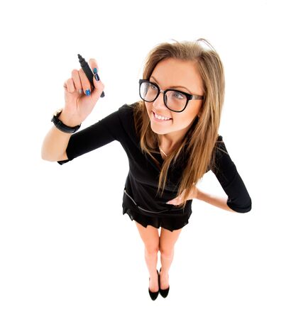 Business woman writing with black marker pen on virtual screen. Young professional smiling wearing suit. Businesswoman isolated on white background.の写真素材