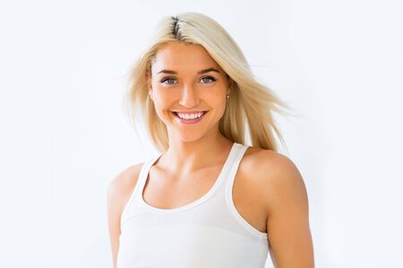Beautiful face of young adult woman with clean fresh skin - isolated on whiteの写真素材