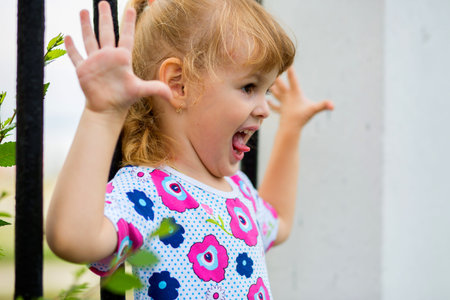 Happy little girl climbing on outdoor playground