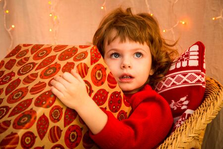 Christmas miracle, magic gift box and a child baby boyの写真素材