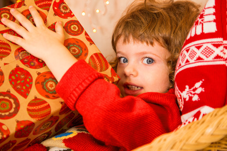 Christmas miracle, magic gift box and a child baby boyの写真素材