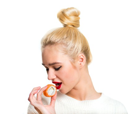 Young woman holding sushi, isolated on whiteの写真素材