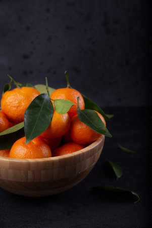 Freshly harvested tangerines from organic farming exposed on dark background.の写真素材