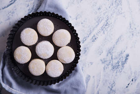 Homemade caramel cookies, decorated with pieces of coconut, confectionery sugar and caramel spread.の写真素材