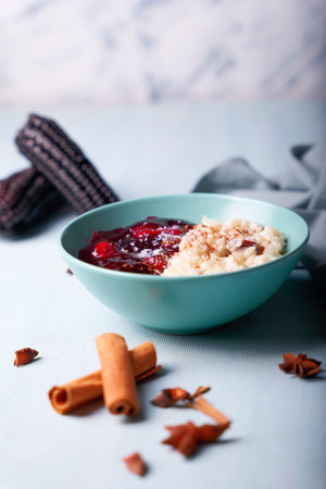 Typical Peruvian dessert: rice pudding and purple mazamorra on a light blue background.の写真素材