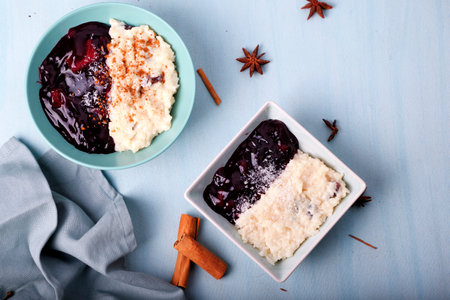 Typical Peruvian dessert: rice pudding and purple mazamorra on a light blue background.の写真素材