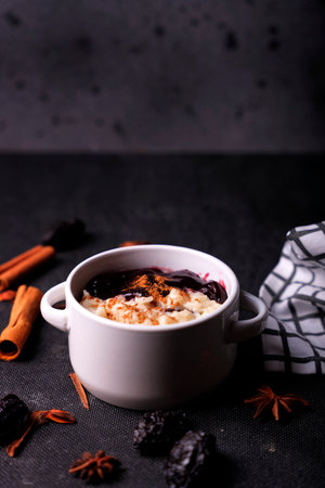 Typical Peruvian dessert: rice pudding and purple mazamorra on a dark background.の写真素材