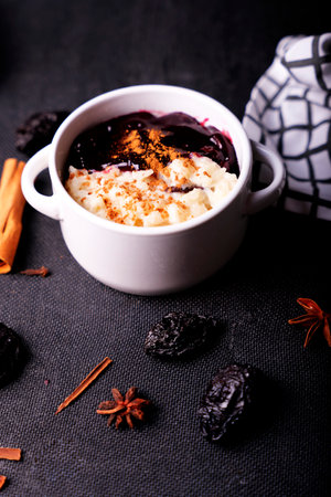 Typical Peruvian dessert: rice pudding and purple mazamorra on a dark background.の写真素材
