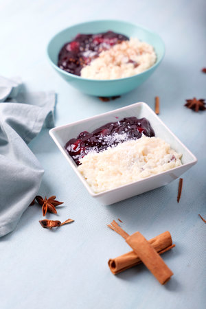 Typical Peruvian dessert: rice pudding and purple mazamorra on a light blue background.の写真素材